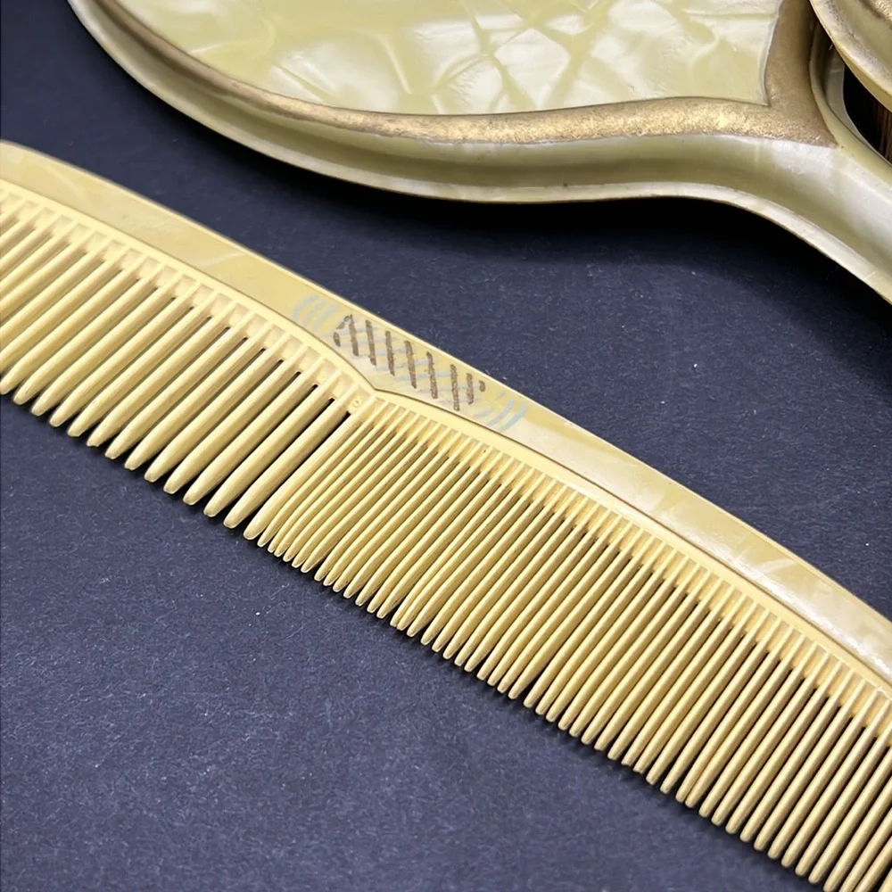 Vintage yellow celluloid vanity mirror, comb and brush set